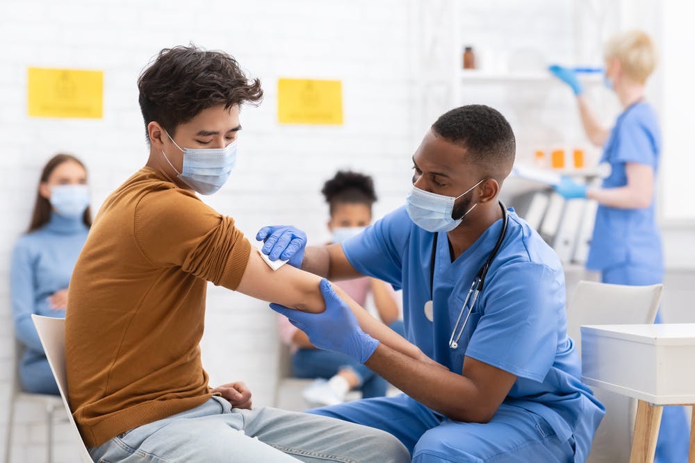 An Asian male getting the Covid-19 vaccination 